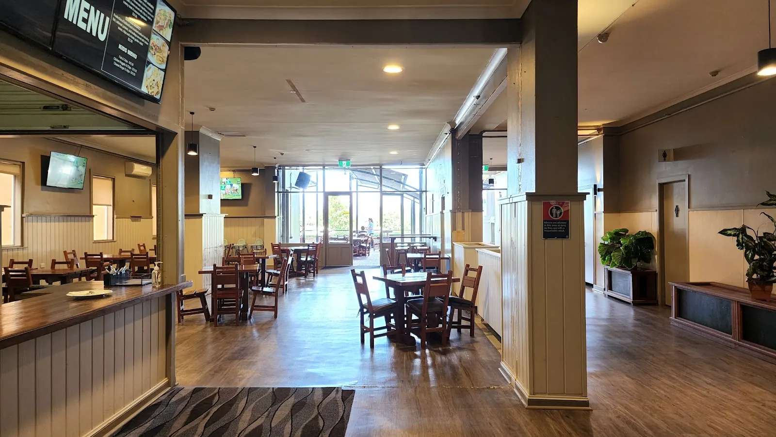 The bistro dining room with timber tables, screens and the menu board